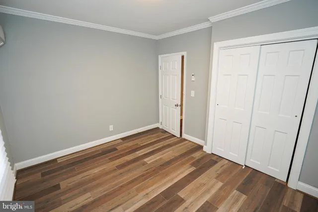 a view of a room with wooden floor