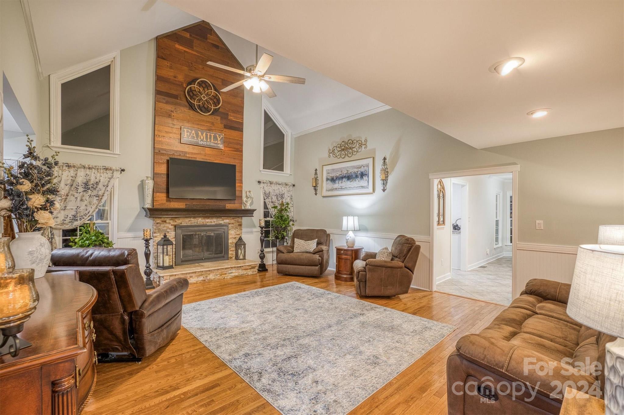 8800 Flowes Store Road Concord, NC 28025 - Photo 11 of 48 a living room with furniture a fireplace and a flat screen tv
