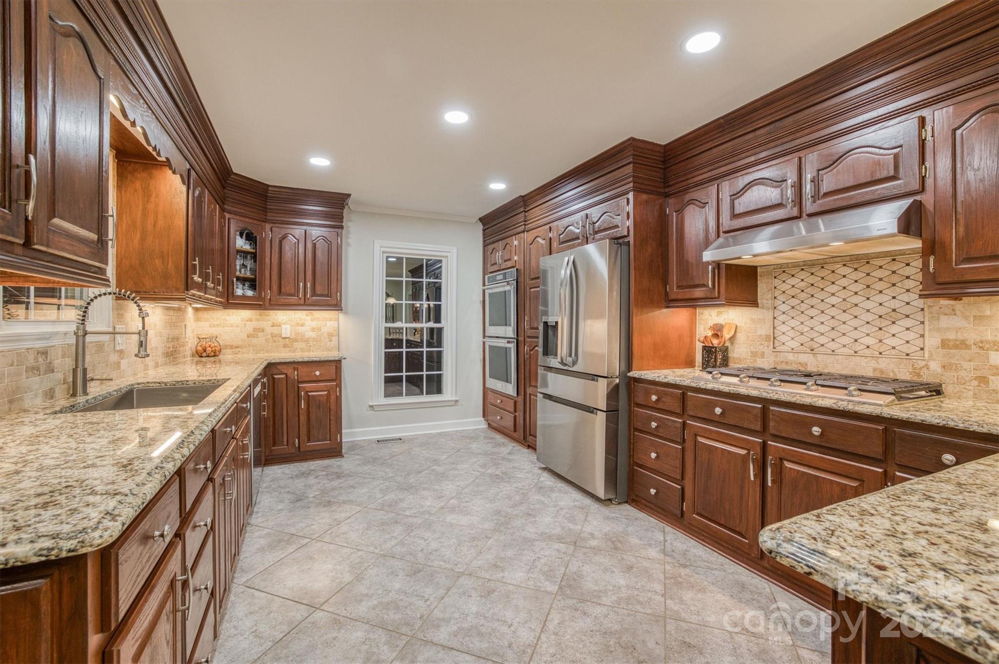 8800 Flowes Store Road Concord, NC 28025 - Photo 13 of 48 a kitchen with stainless steel appliances granite countertop a sink stove and refrigerator