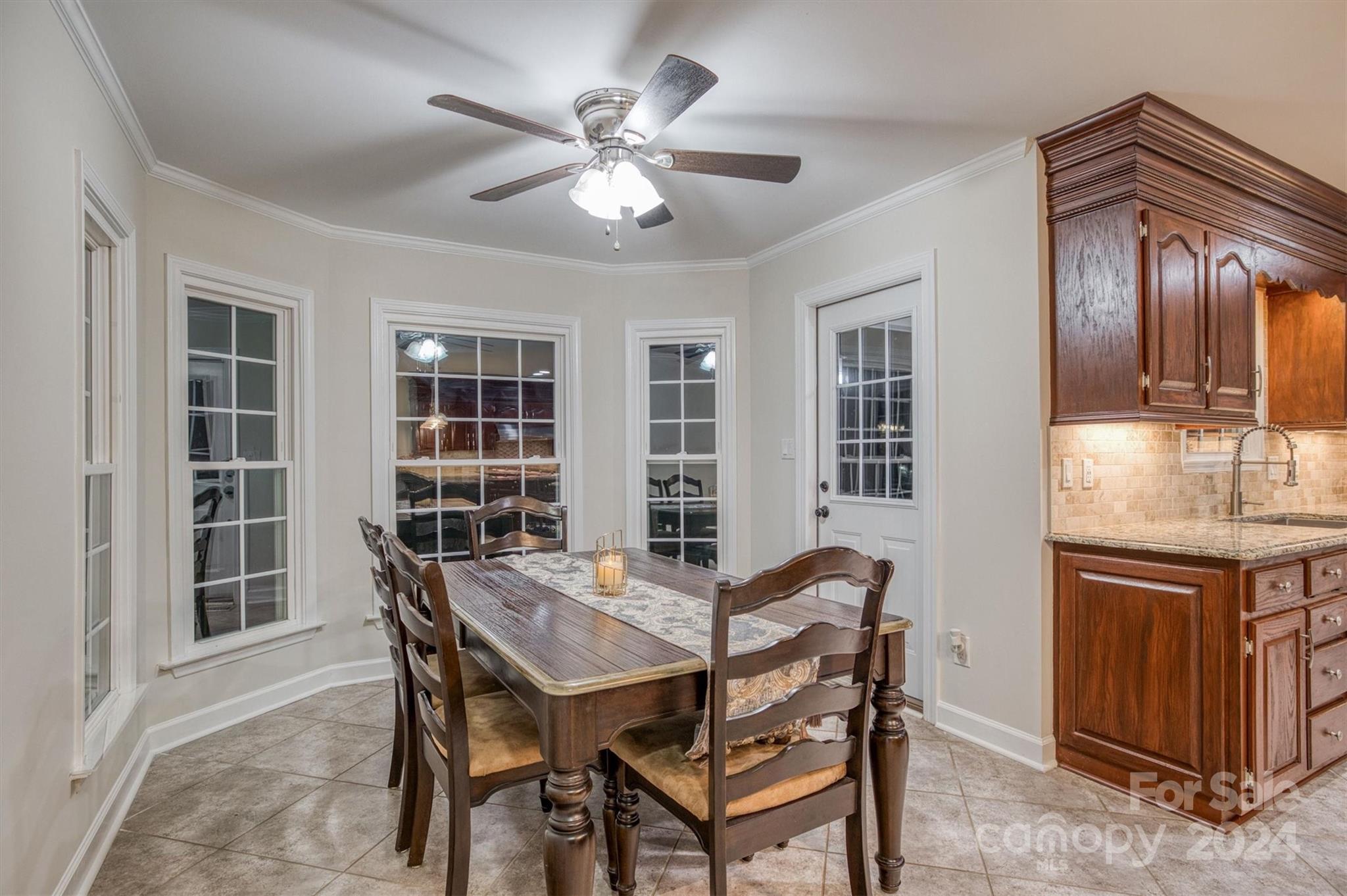 8800 Flowes Store Road Concord, NC 28025 - Photo 15 of 48 a view of a dining room with furniture and chandelier