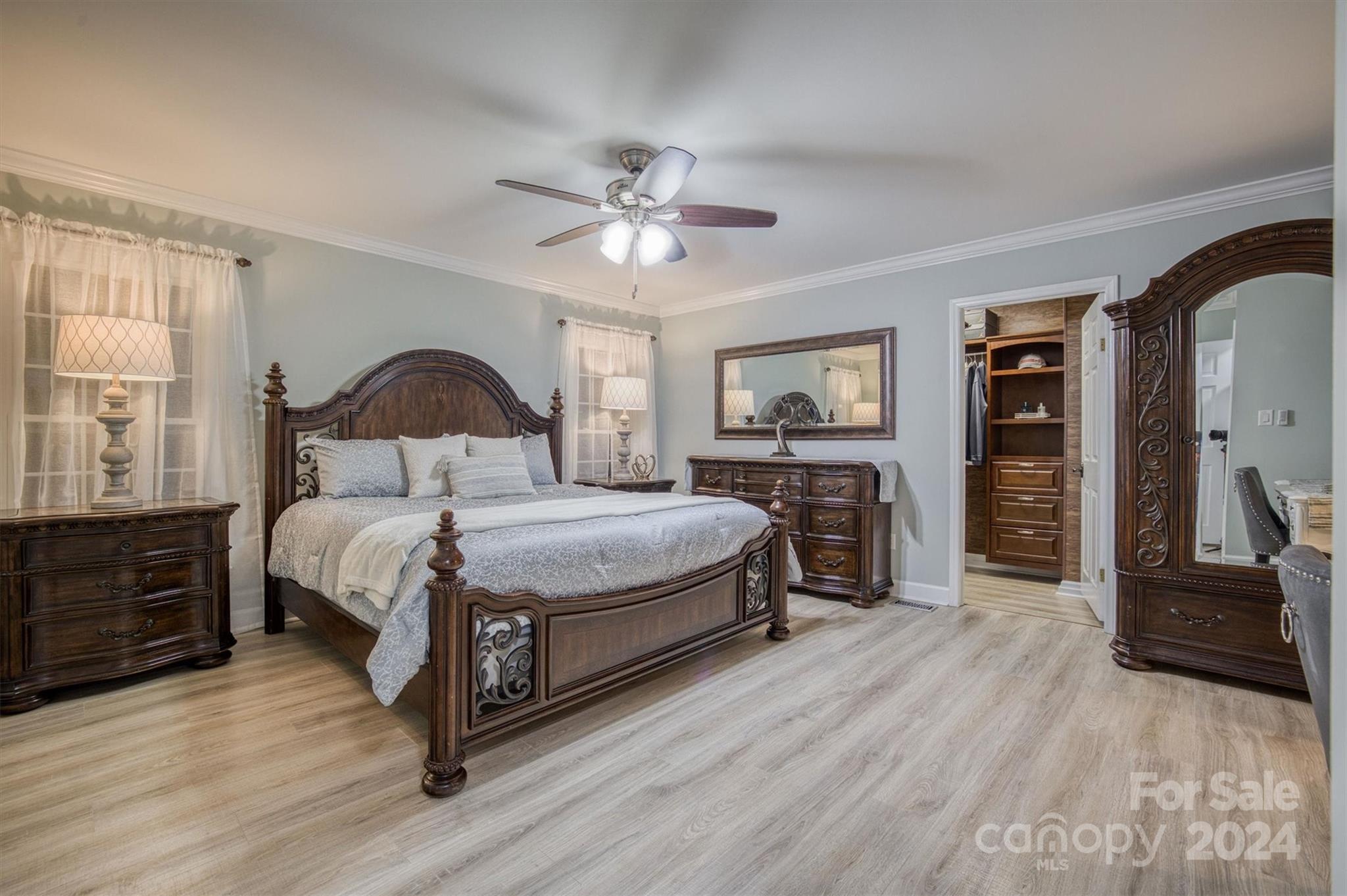 8800 Flowes Store Road Concord, NC 28025 - Photo 16 of 48 a bedroom with a large bed a flat tv screen and dresser