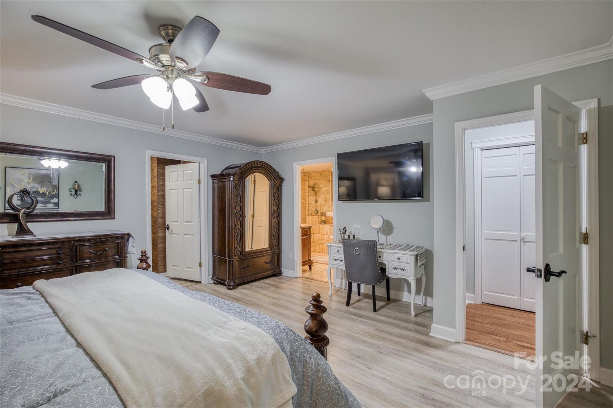 8800 Flowes Store Road Concord, NC 28025 - Photo 17 of 48 a spacious bedroom with a bed and a flat screen tv
