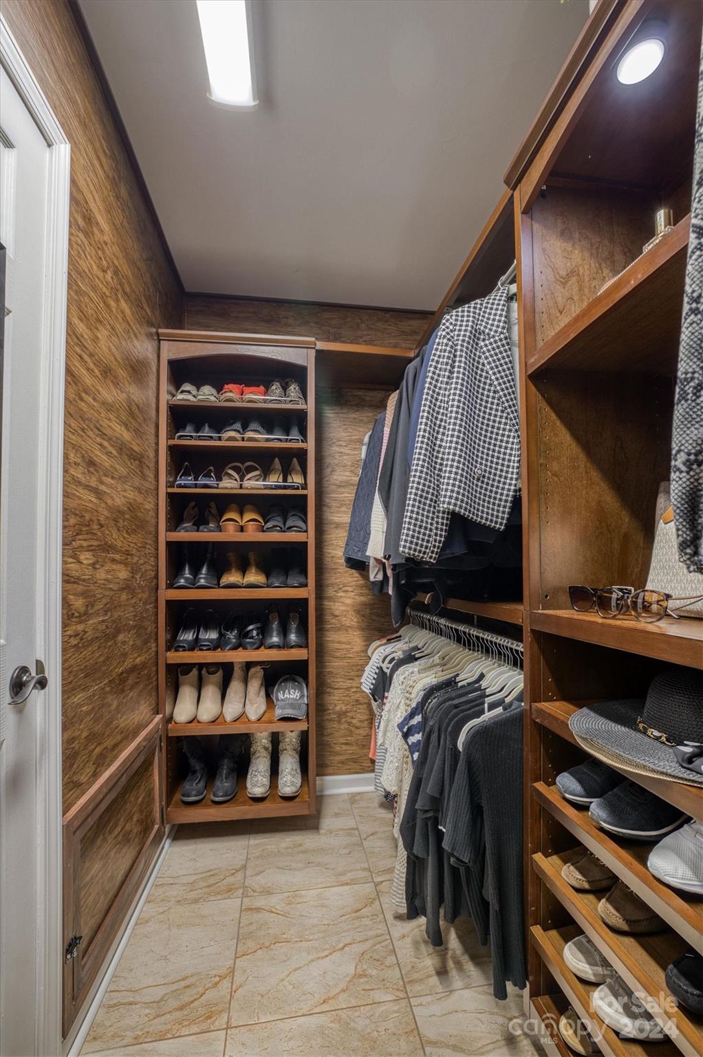 8800 Flowes Store Road Concord, NC 28025 - Photo 20 of 48 a view of walk in closet with clothes and shoes