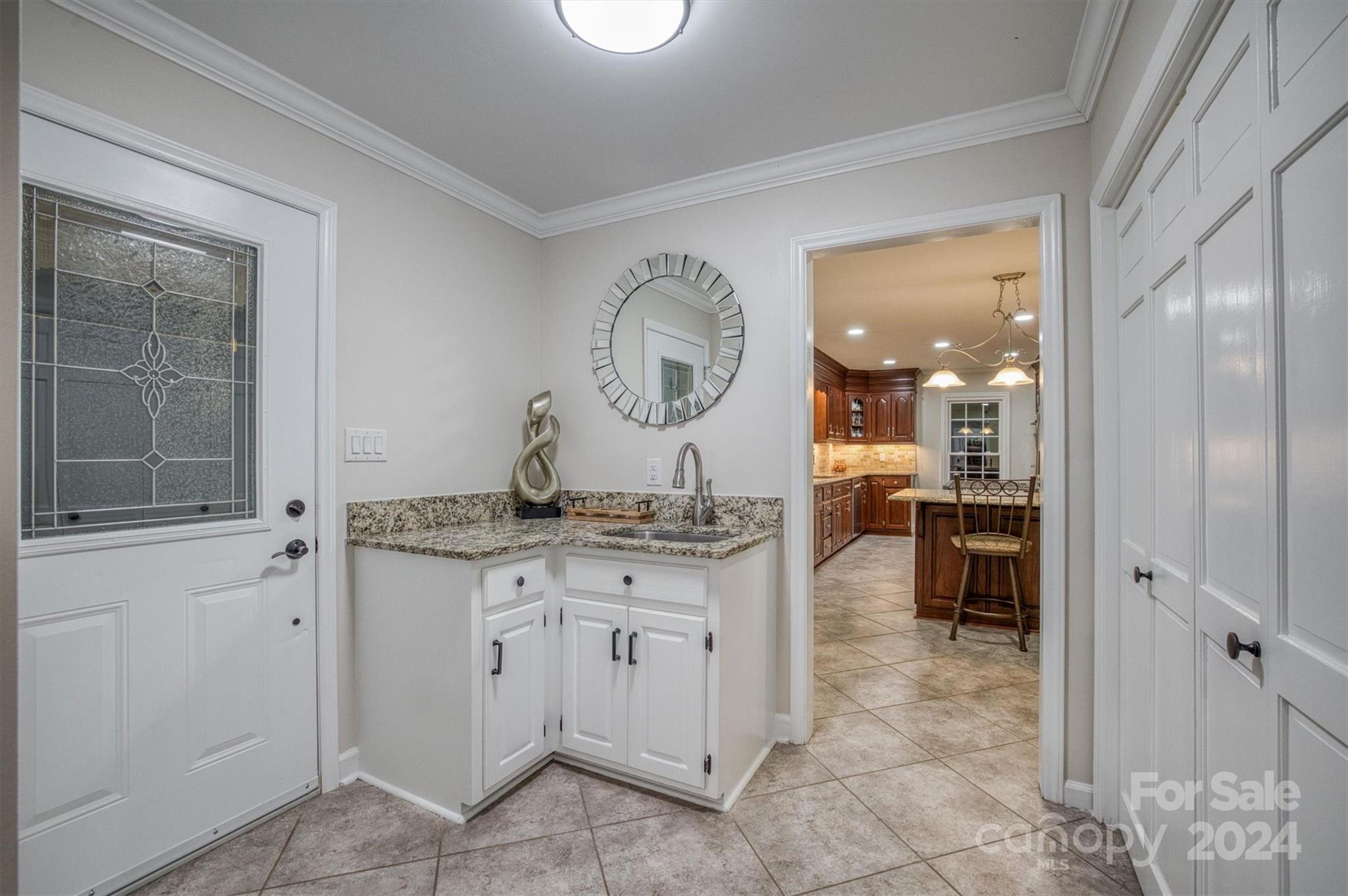 8800 Flowes Store Road Concord, NC 28025 - Photo 24 of 48 a living room with granite countertop furniture a mirror and a sink