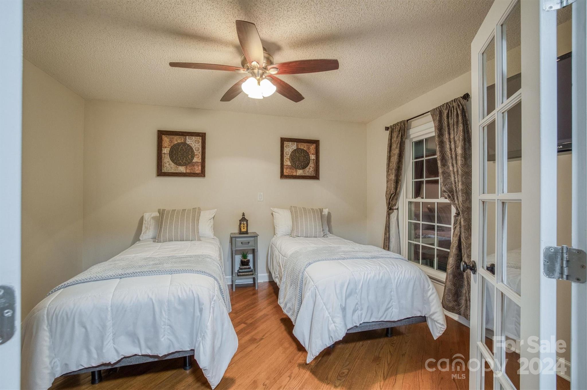 8800 Flowes Store Road Concord, NC 28025 - Photo 28 of 48 a bedroom with a bed and a chandelier