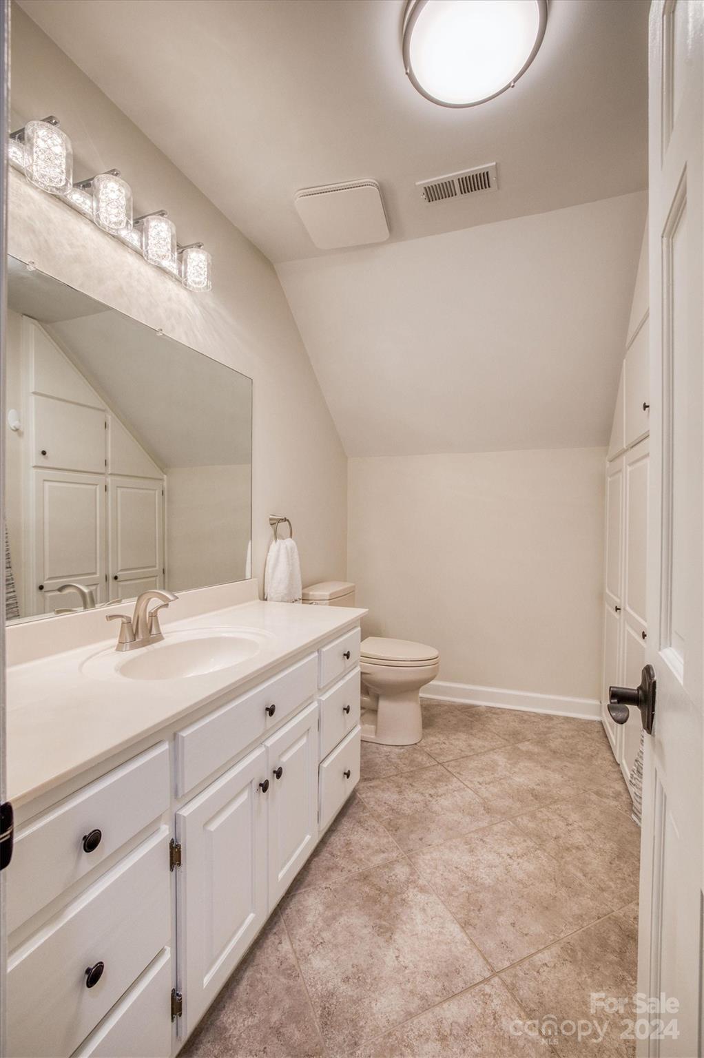 8800 Flowes Store Road Concord, NC 28025 - Photo 30 of 48 a bathroom with a double vanity sink toilet and a mirror
