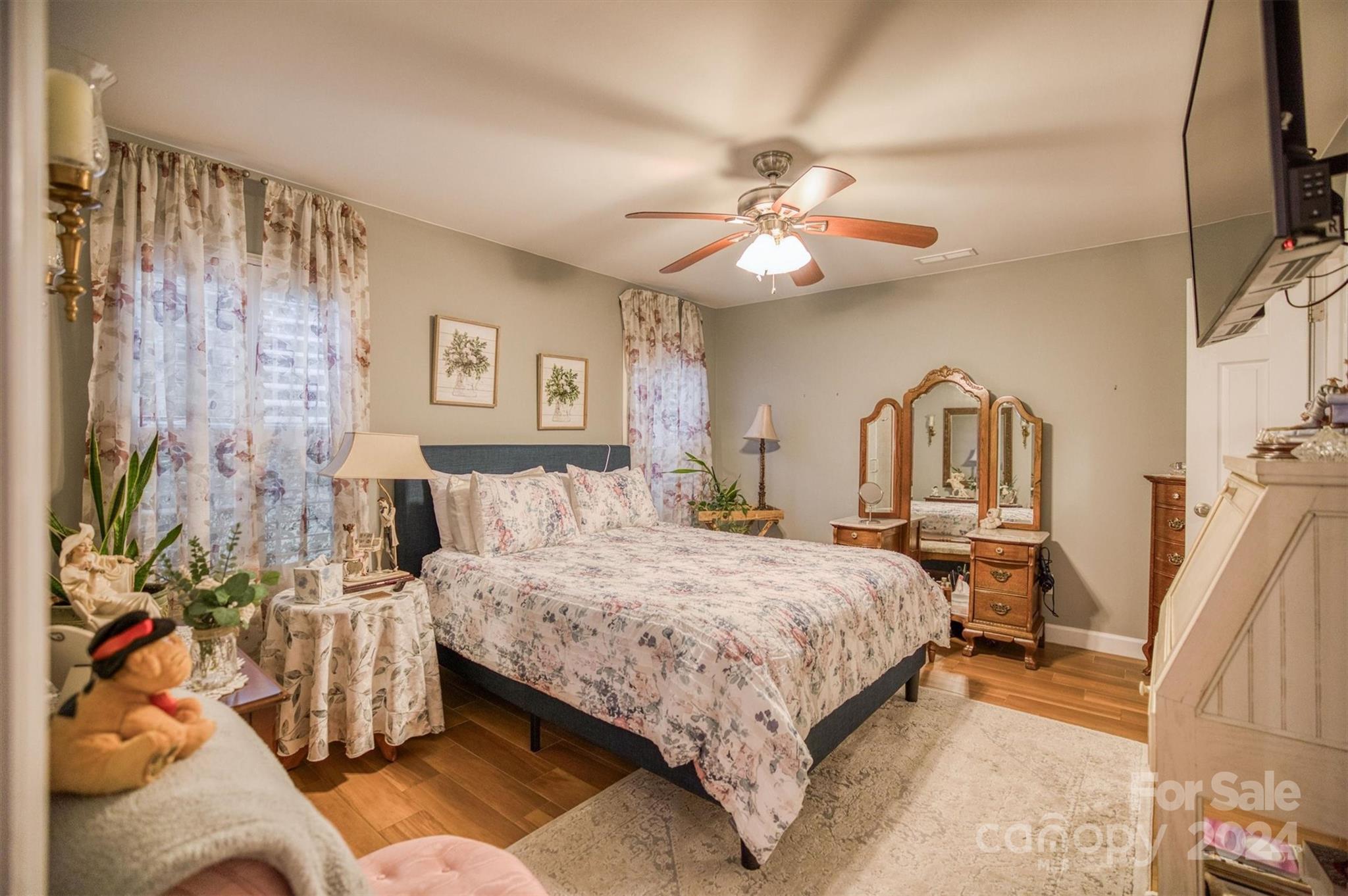 8800 Flowes Store Road Concord, NC 28025 - Photo 38 of 48 a bedroom with a bed and a chandelier