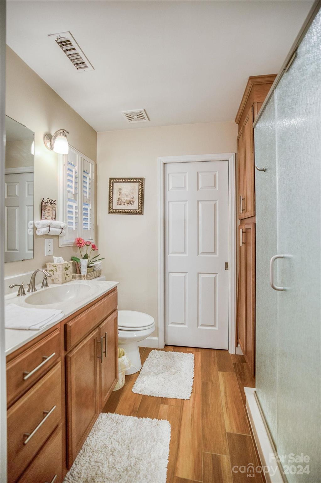 8800 Flowes Store Road Concord, NC 28025 - Photo 39 of 48 a spacious bathroom with a granite countertop sink toilet and shower