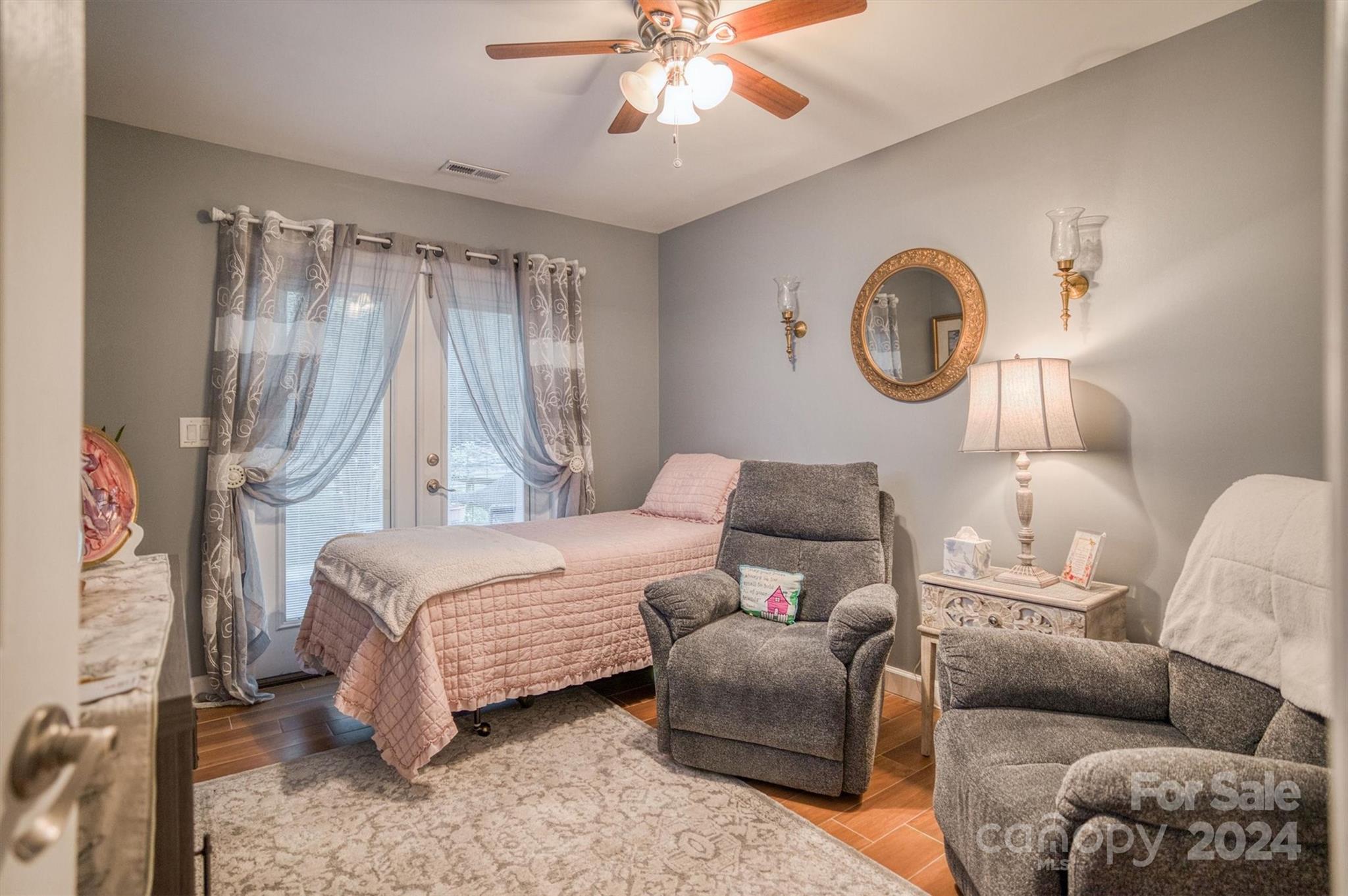 8800 Flowes Store Road Concord, NC 28025 - Photo 40 of 48 a bedroom with a bed and a chandelier