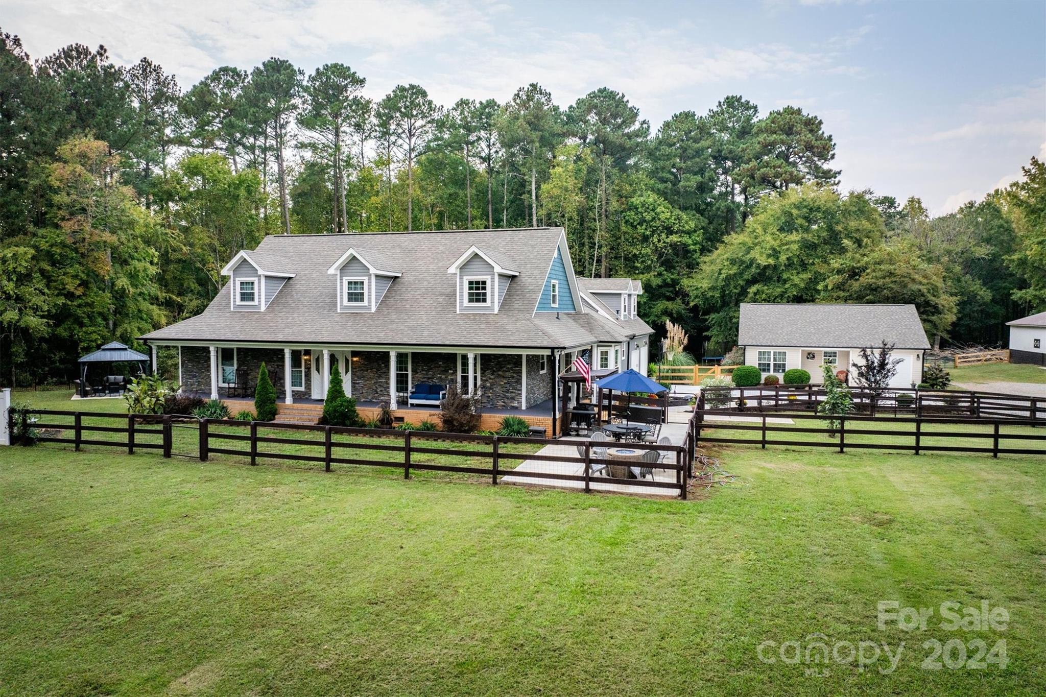 8800 Flowes Store Road Concord, NC 28025 - Photo 8 of 48 an aerial view of a house with swimming pool garden view and a table and chairs