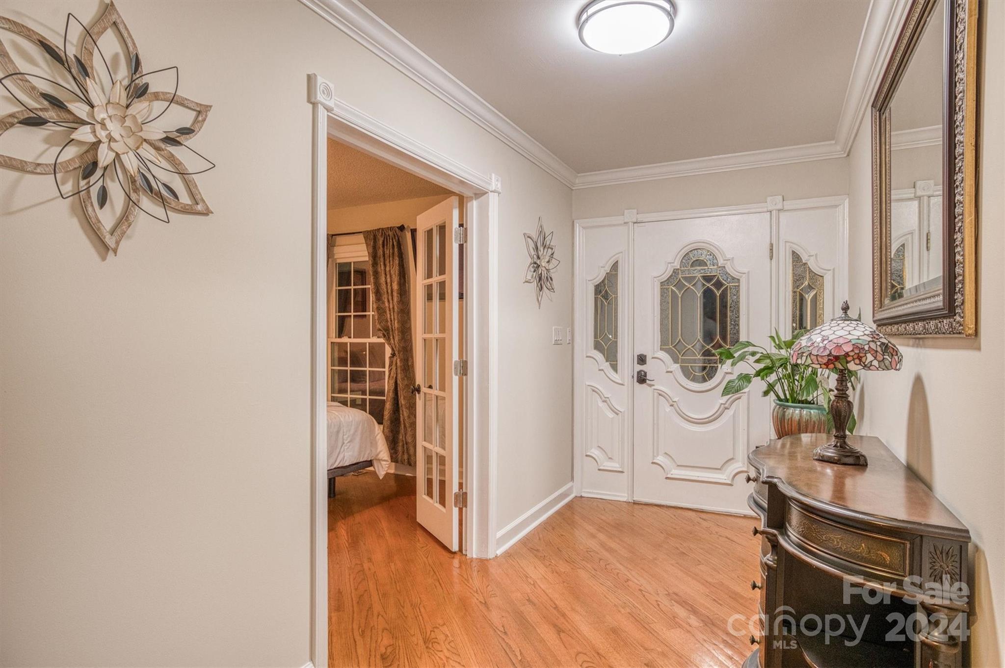 8800 Flowes Store Road Concord, NC 28025 - Photo 10 of 48 a view of a hallway with entryway wooden floor and front door