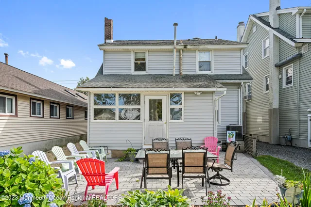 a front view of house with yard and outdoor seating