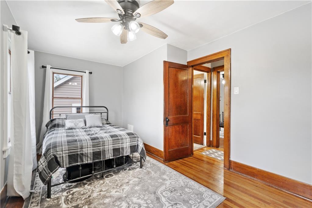 583 Adams Street Rochester, PA 15074 - Photo 21 of 35 a bedroom with a bed and wooden floor