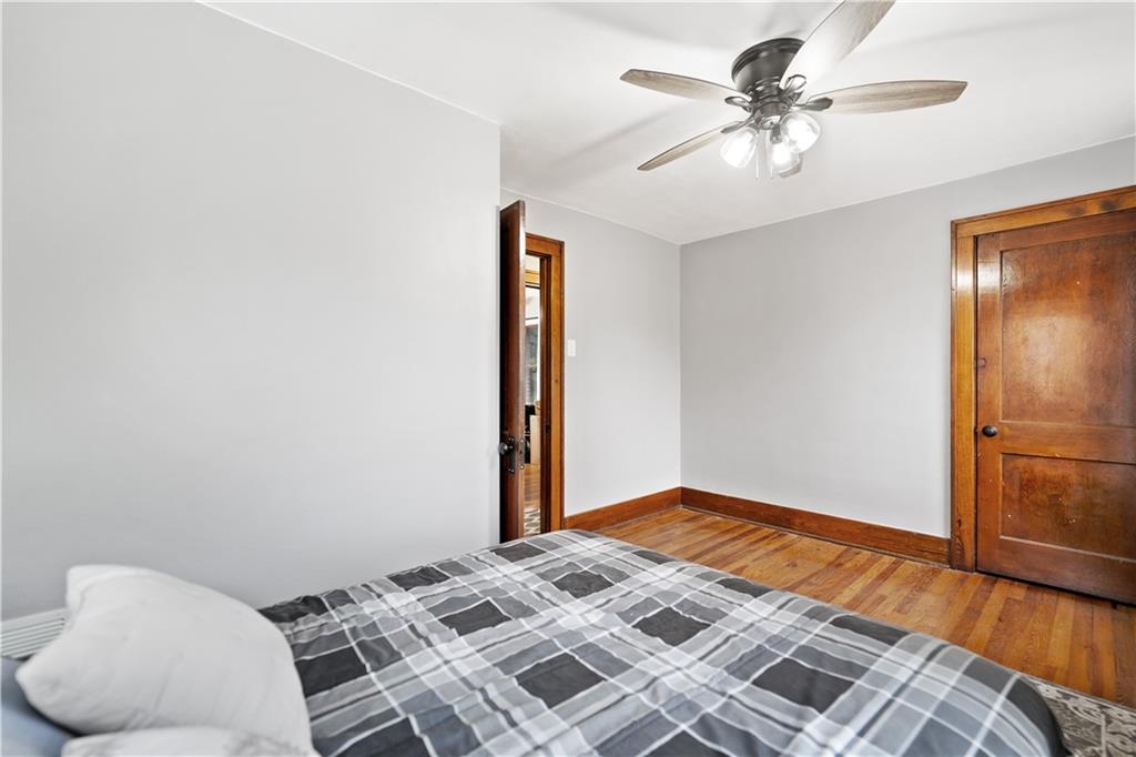 583 Adams Street Rochester, PA 15074 - Photo 22 of 35 a bedroom with a bed and a chandelier