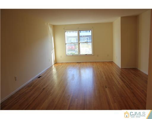 4407 Hana Road Edison, NJ 08817 - Photo 2 of 10 a view of an empty room with wooden floor and a window