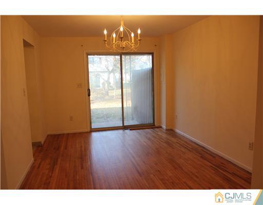 4407 Hana Road Edison, NJ 08817 - Photo 3 of 10 a view of an empty room with wooden floor and windows
