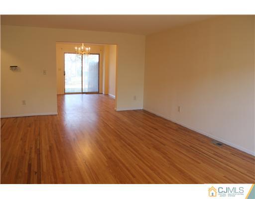 4407 Hana Road Edison, NJ 08817 - Photo 4 of 10 a view of an empty room and wooden floor