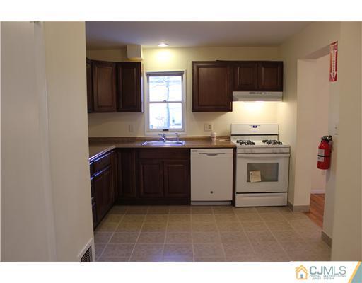 4407 Hana Road Edison, NJ 08817 - Photo 5 of 10 a kitchen with a sink stove and microwave