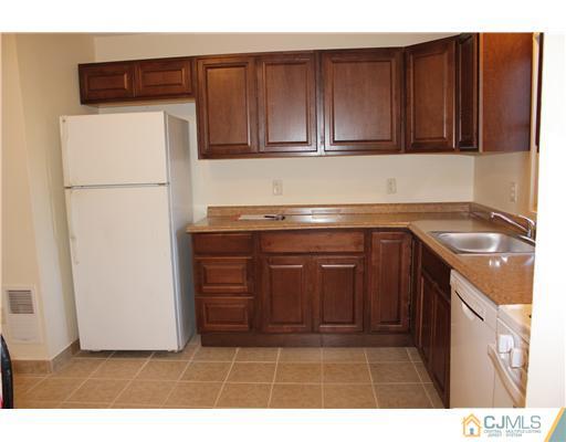 4407 Hana Road Edison, NJ 08817 - Photo 6 of 10 a kitchen with stainless steel appliances granite countertop a refrigerator a stove a sink and dishwasher