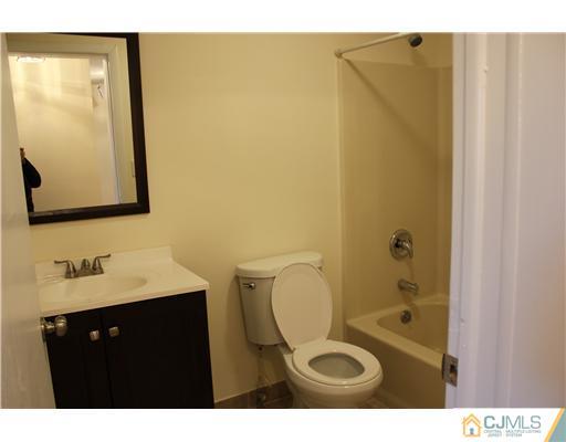 4407 Hana Road Edison, NJ 08817 - Photo 8 of 10 a bathroom with a sink and a mirror