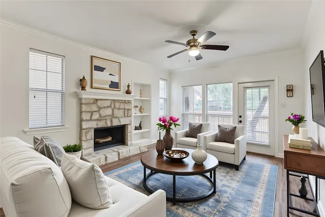 a living room with furniture fireplace and window