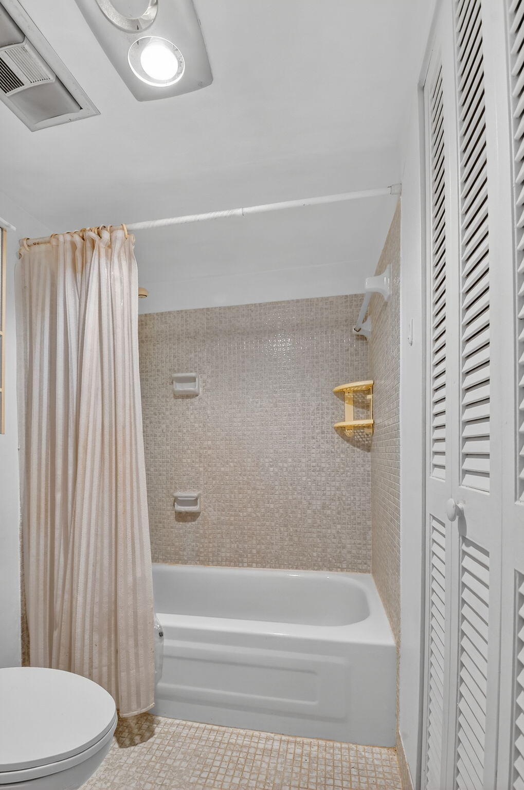 13682 Vía Flora, Unit D Delray Beach, FL 33484 - Photo 15 of 27 a bathroom with a toilet and a bathtub