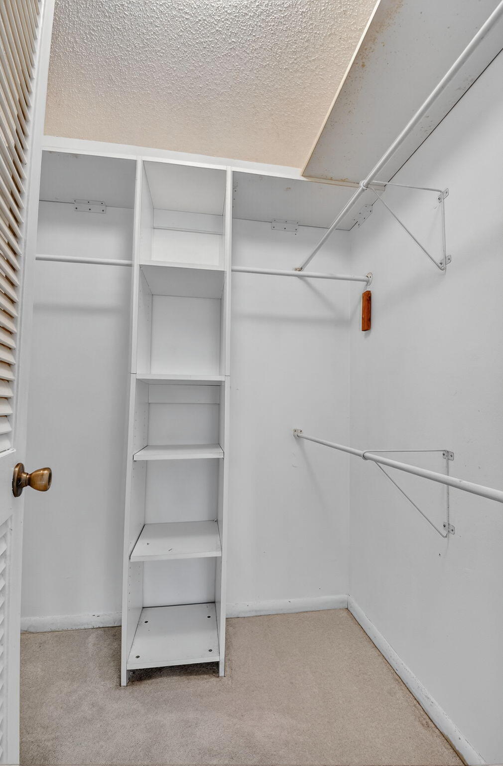 13682 Vía Flora, Unit D Delray Beach, FL 33484 - Photo 16 of 27 a view of an empty walk in closet