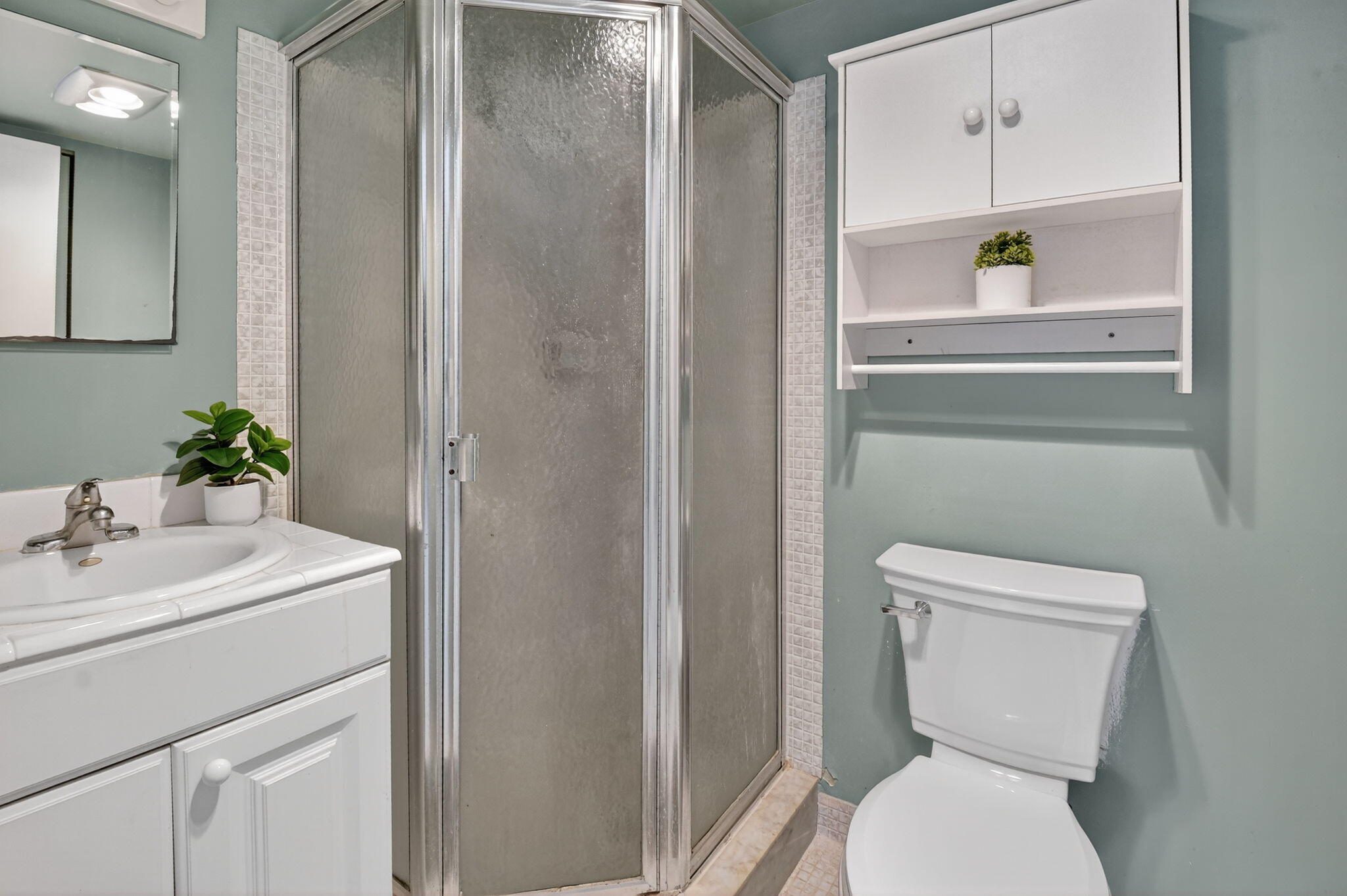 13682 Vía Flora, Unit D Delray Beach, FL 33484 - Photo 19 of 27 a bathroom with a toilet a sink and a mirror