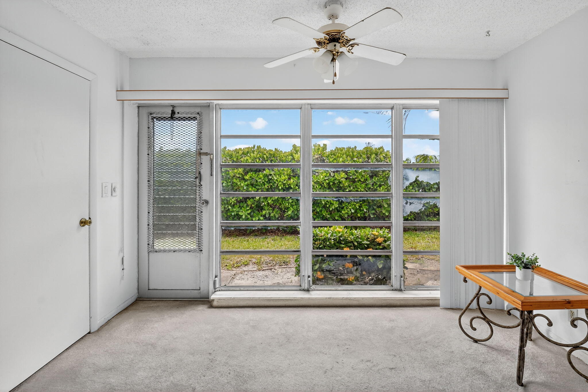 13682 Vía Flora, Unit D Delray Beach, FL 33484 - Photo 4 of 27 a view of a livingroom with furniture window and outside view