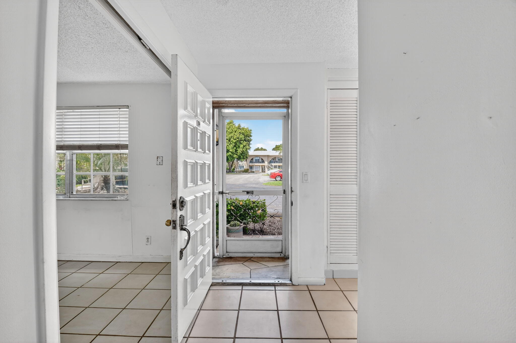 13682 Vía Flora, Unit D Delray Beach, FL 33484 - Photo 5 of 27 a view of an entryway with wooden floor