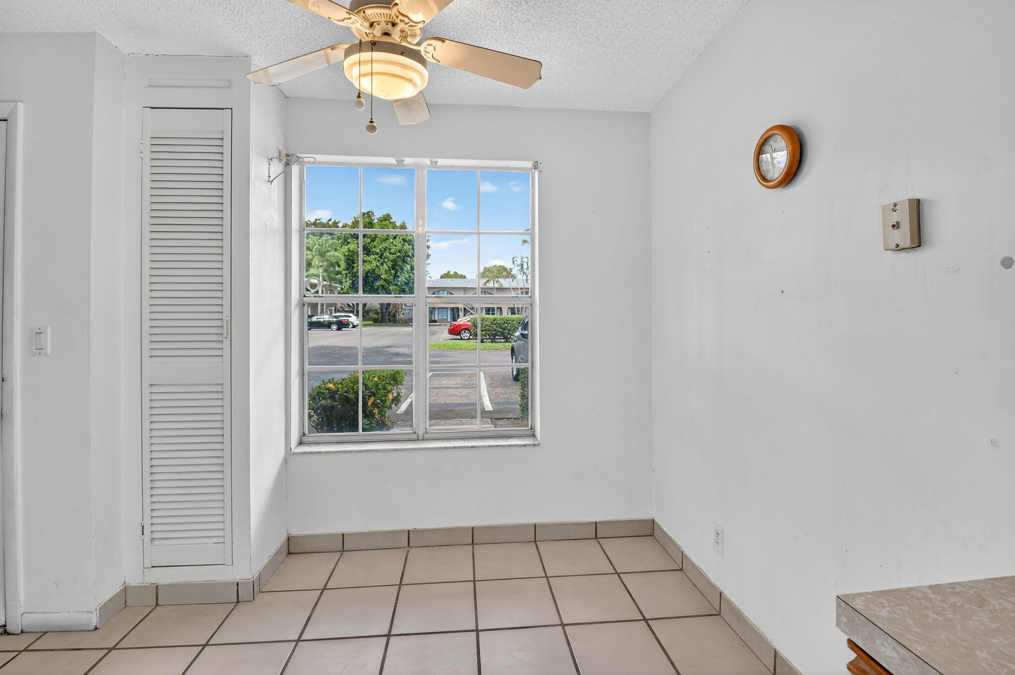 13682 Vía Flora, Unit D Delray Beach, FL 33484 - Photo 6 of 27 a view of an entryway with window and ceiling fan