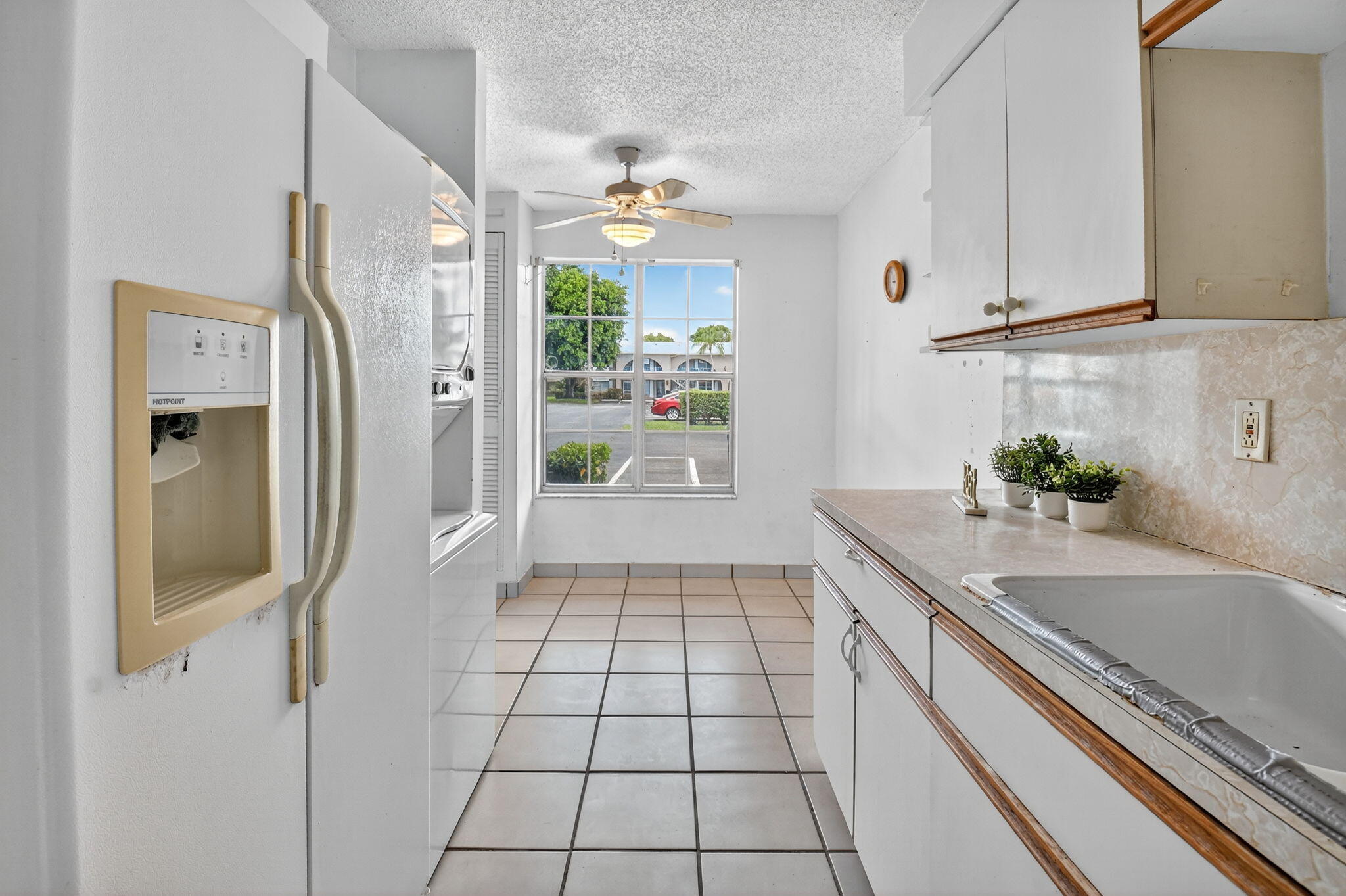 13682 Vía Flora, Unit D Delray Beach, FL 33484 - Photo 7 of 27 a kitchen with a sink and cabinets