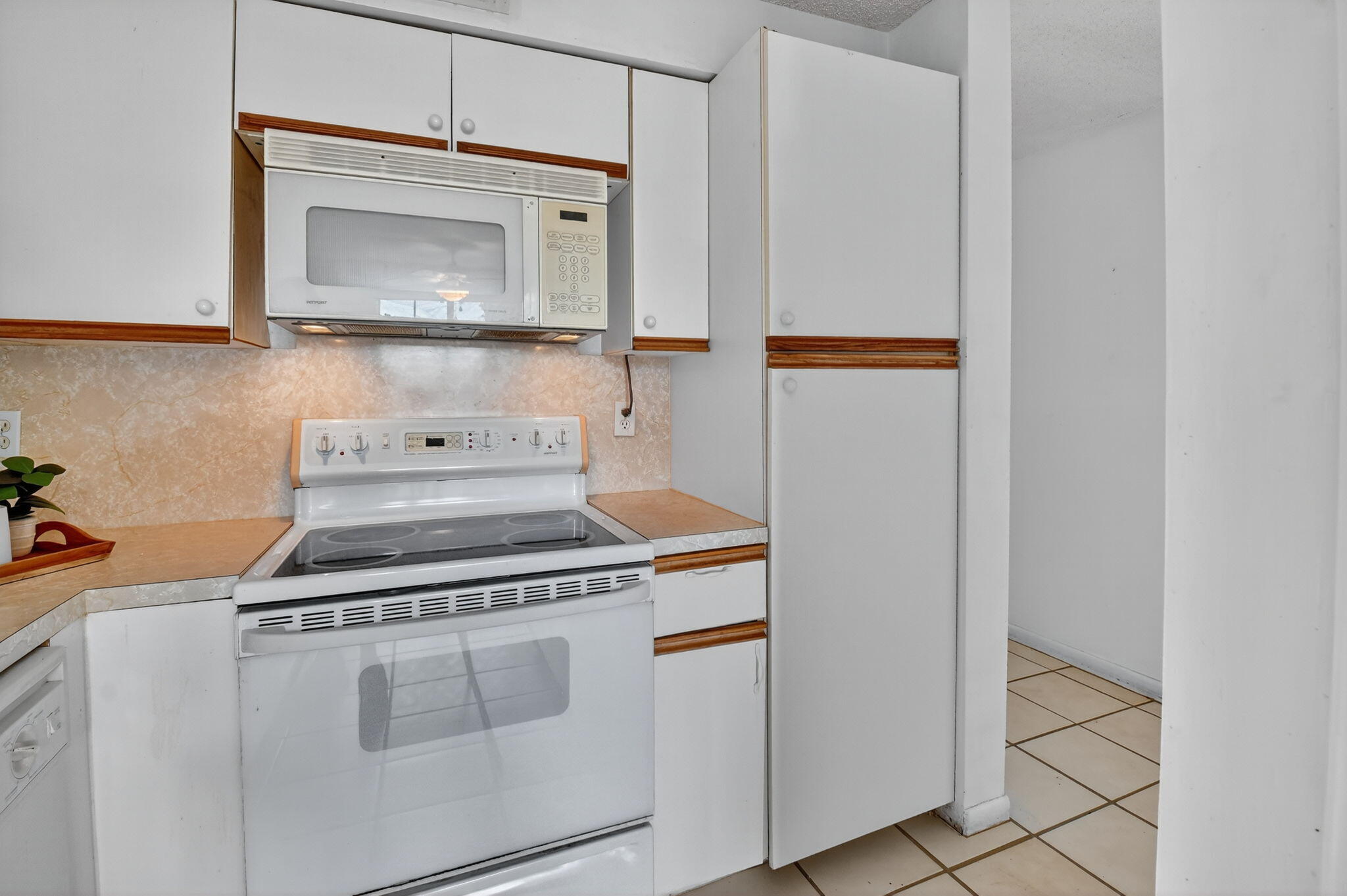 13682 Vía Flora, Unit D Delray Beach, FL 33484 - Photo 8 of 27 a stove top oven sitting inside of a kitchen