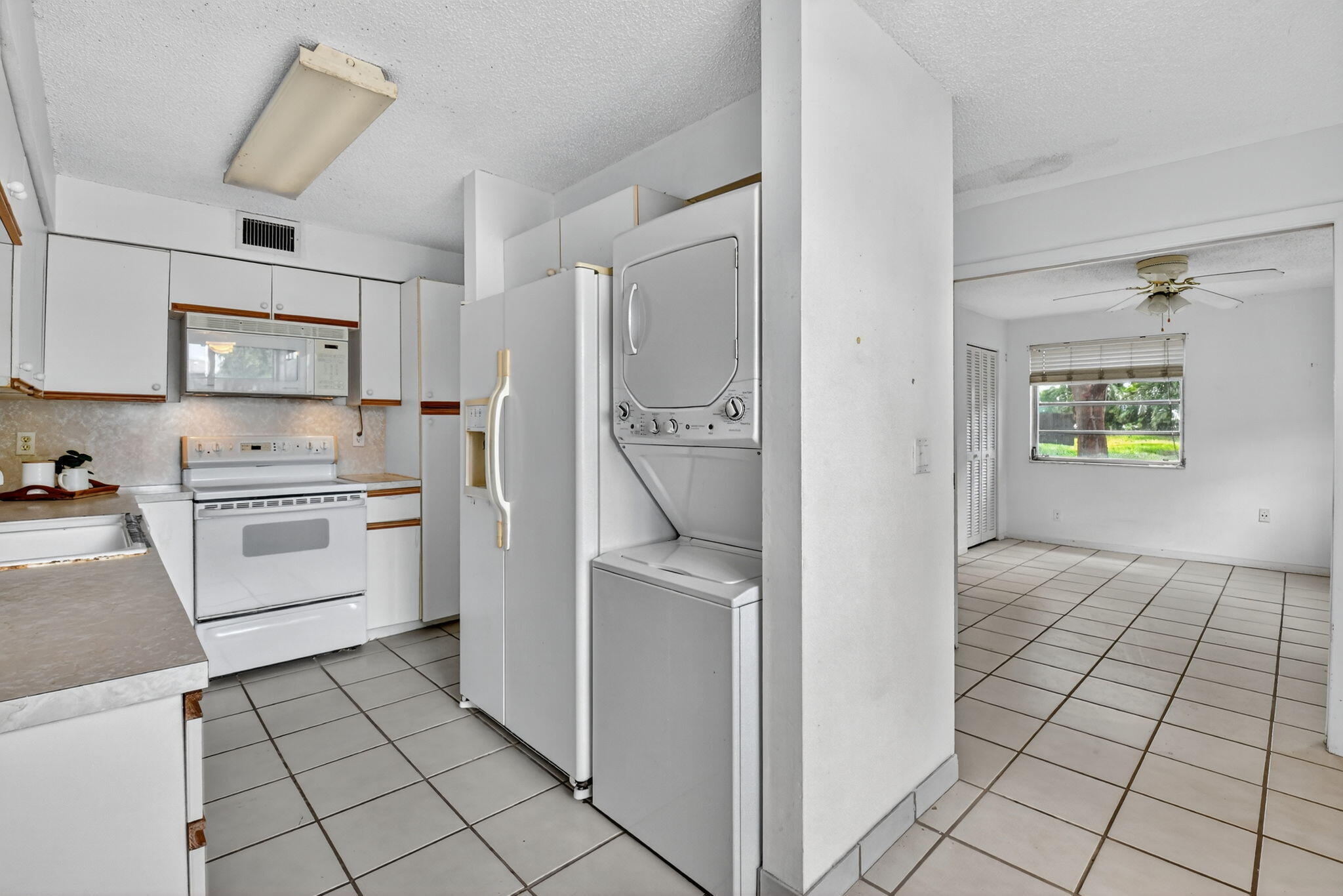 13682 Vía Flora, Unit D Delray Beach, FL 33484 - Photo 9 of 27 a kitchen with white cabinets and appliances