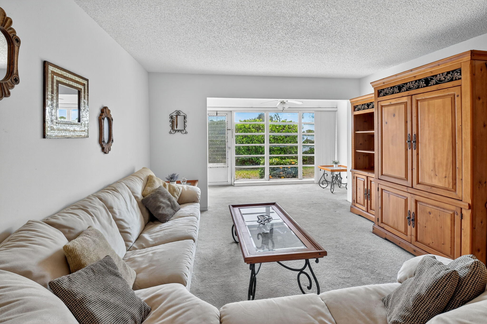 13682 Vía Flora, Unit D Delray Beach, FL 33484 - Photo 10 of 27 a living room with furniture and a window