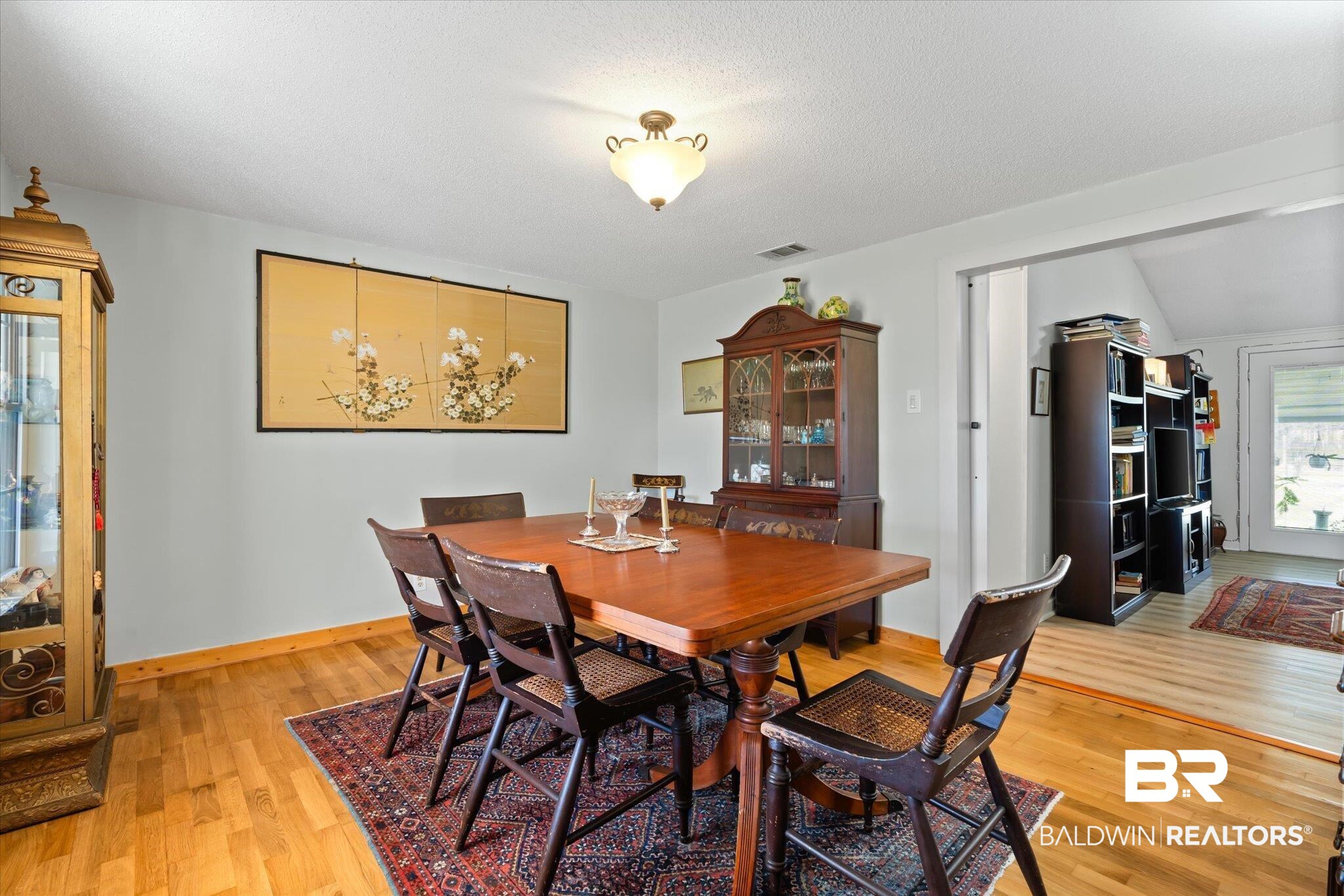 14280 Cat Deakle Road Grand Bay, AL 36541 - Photo 9 of 51 Dining space with baseboards, a textured ceiling, visible vents, and light wood-style floors