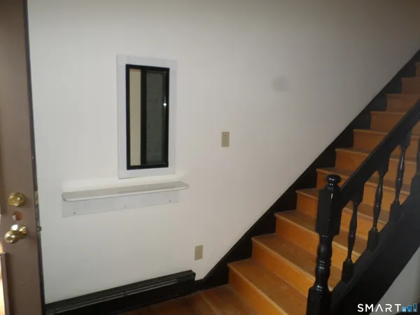 a view of entryway with wooden floor