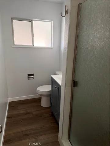 a bathroom with a toilet and a window