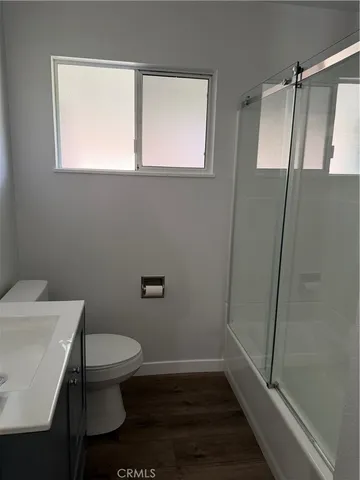 a bathroom with a toilet a sink and a shower