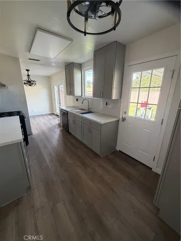 a living room with couches and cabinets with wooden floor