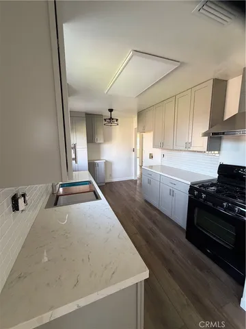 a large kitchen with a stove and a sink