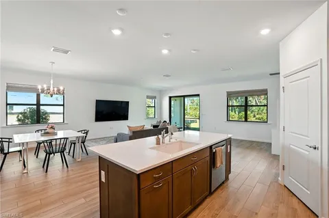 a kitchen with a sink and wooden floor