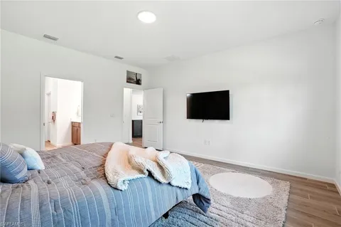 a bedroom with a bed and a flat screen tv