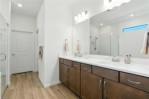 a bathroom with a double vanity sink and mirror