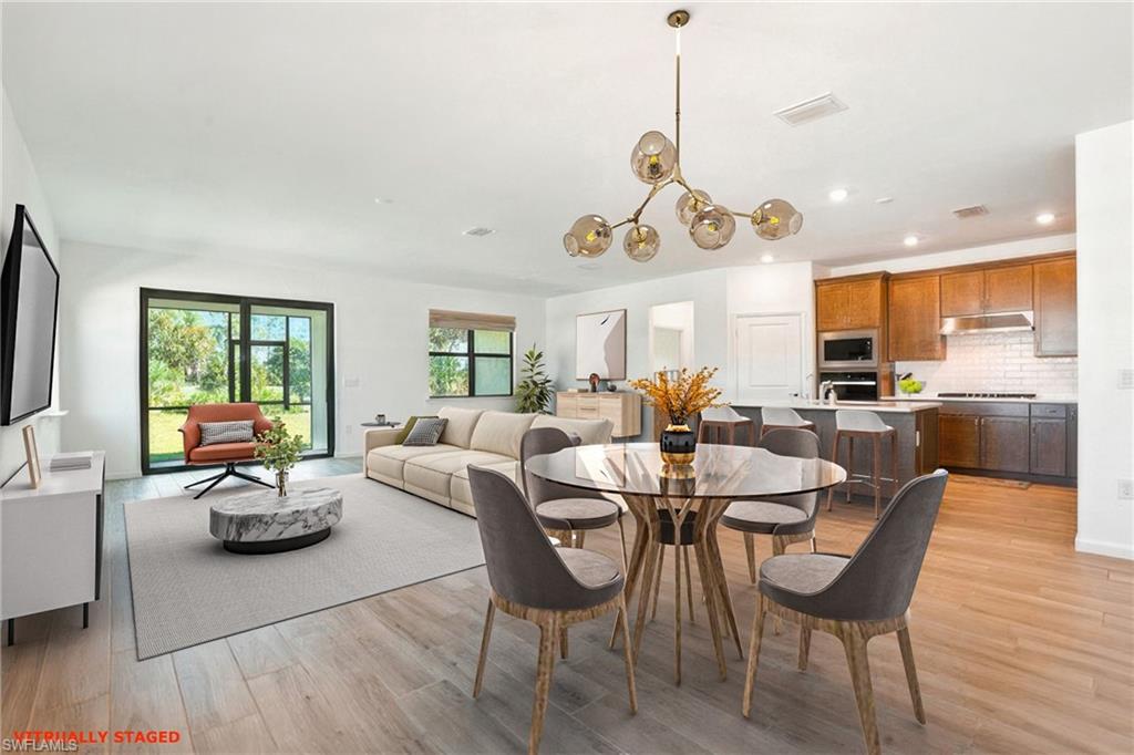2003 Don Benito Way Naples, FL 34120 - Photo 2 of 45 a view of a dining room with furniture window and wooden floor
