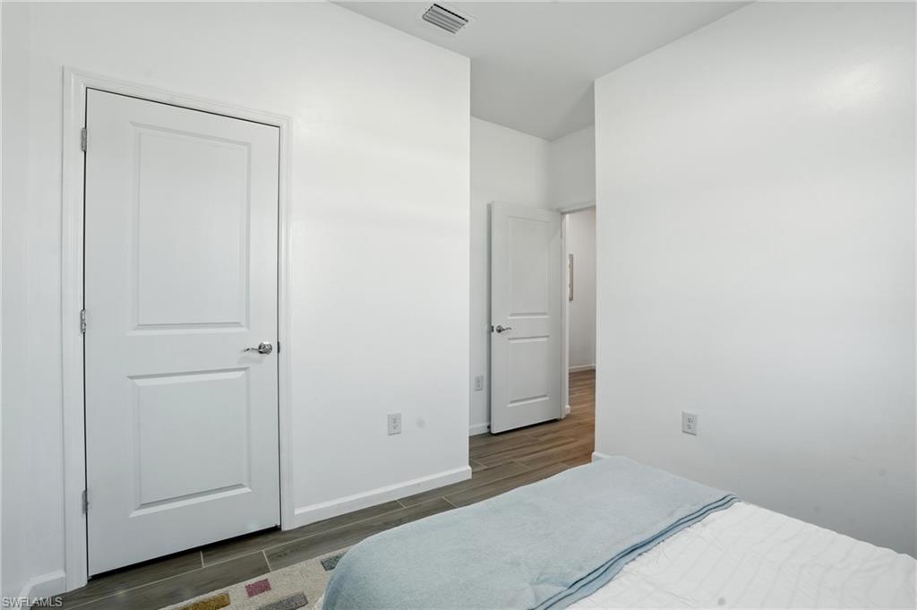 2003 Don Benito Way Naples, FL 34120 - Photo 28 of 45 a bedroom with a bed and utility room