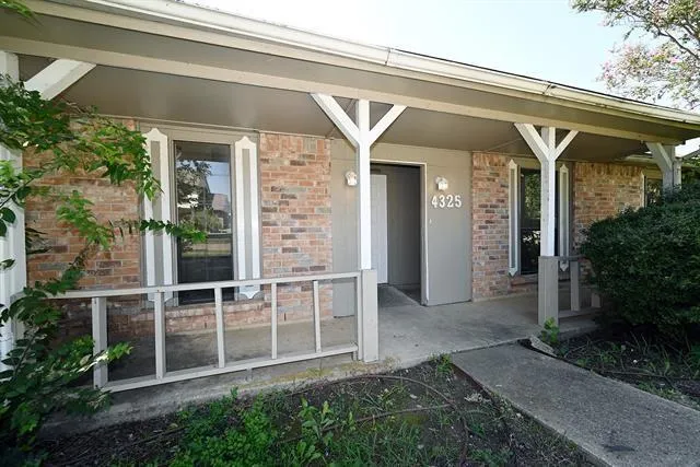 a view of a porch with a table and chair