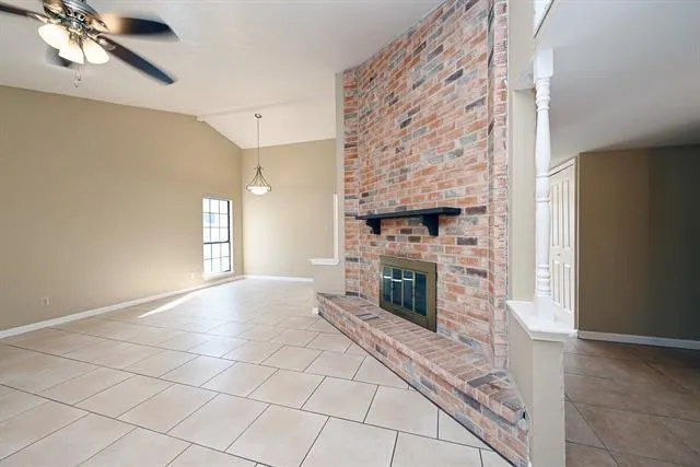 a view of empty room with fireplace and fan