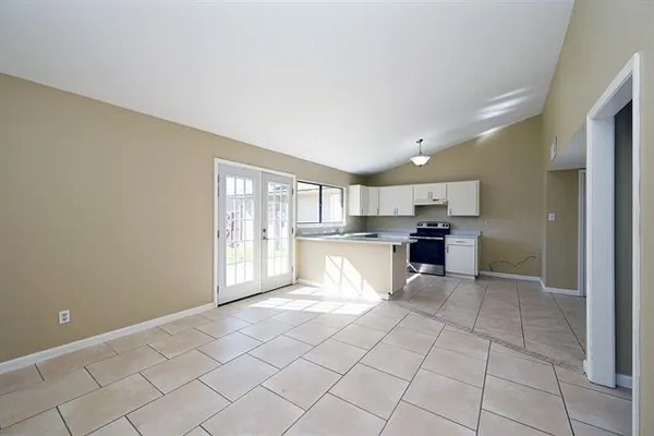 a view of kitchen with white cabinets and sink