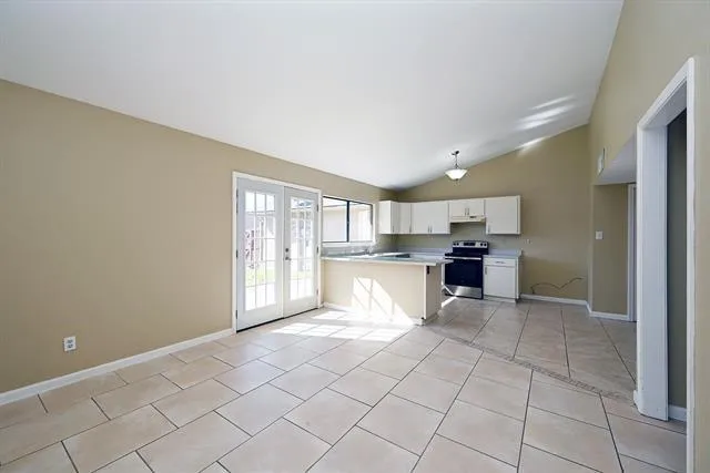 a view of kitchen with white cabinets and sink